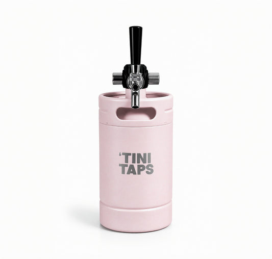 Pink mini keg with tap and 'Tini Taps logo on white background.